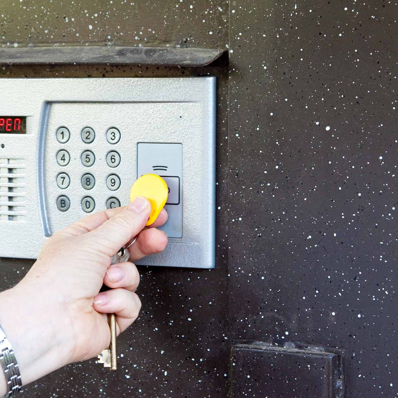 Close-up of uses intercom in steel door